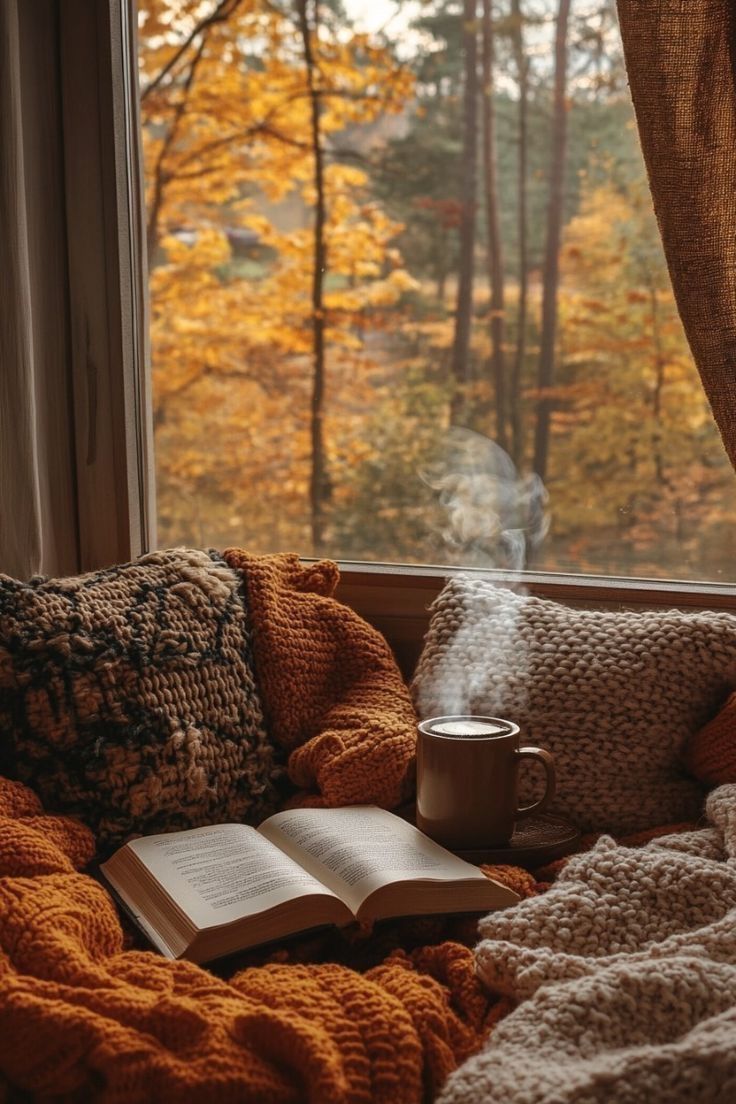 Open book and mug in a window nook