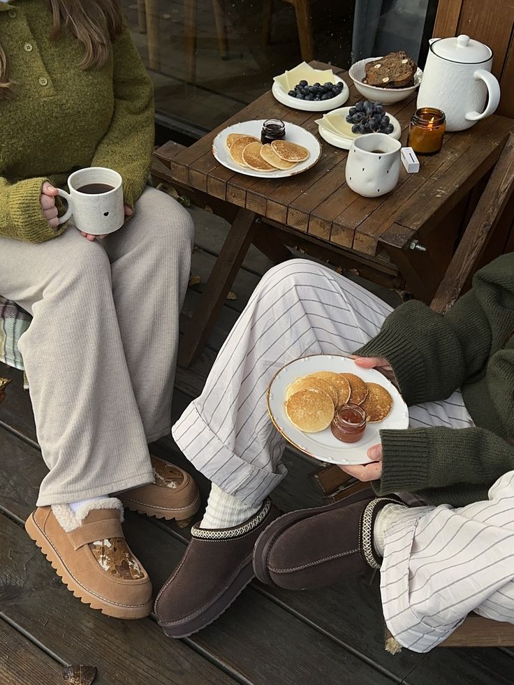 Friends with coffee and pancakes on a cabin deck