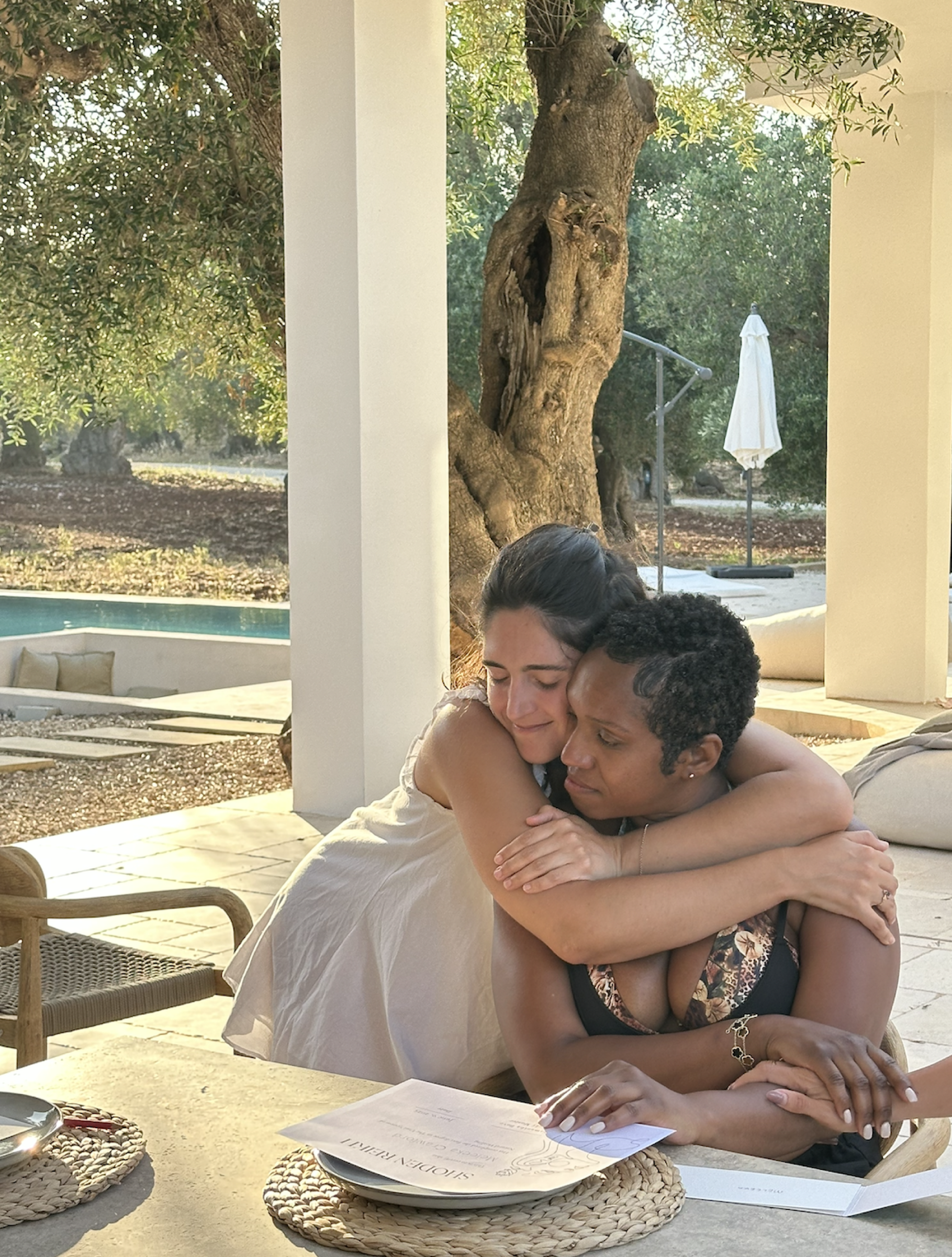 Meleeka embraced by a retreat sister